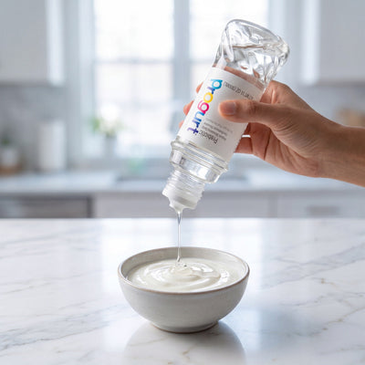 Progurt Prebiotic syrup drizzled into probiotic yogurt — Foundation in a daily routine
